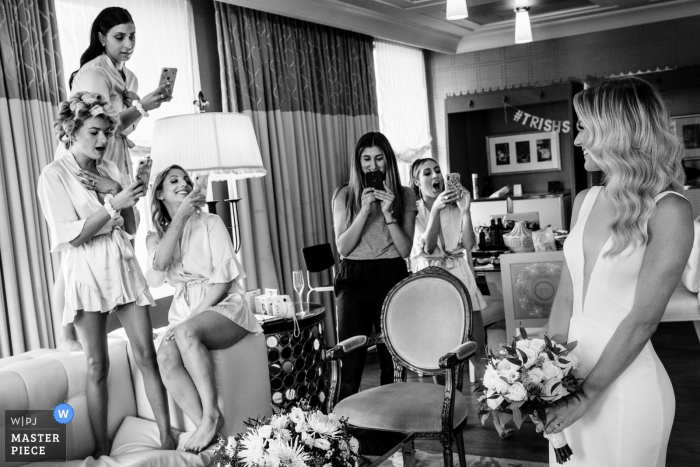 Bridesmaids, and Hair Stylist, asking the bride to pose before they head off to their rooms to get dressed Hotel Getting Ready Photos - Bridesmaids, and Hair Stylist, asking the bride to pose before they head off to their rooms to get dressed.