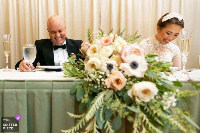 Newnan Centre reception photo of the bride and groom reacting to the toast