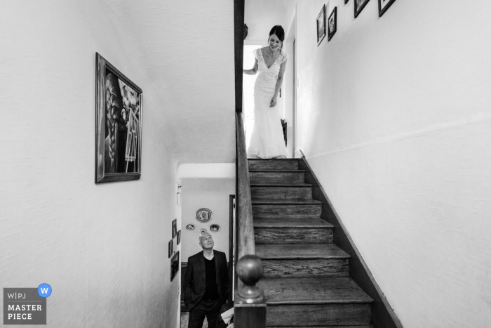 Cotes-d'Armor wedding photo of the bride ready to ascend the stairway before the ceremony.