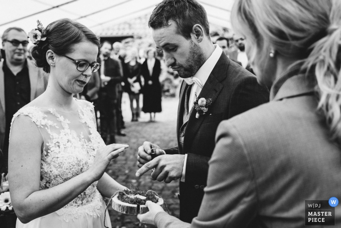 Photo by: <a href="https://www.wpja.com/contests/2019-v15/best-wedding-photographers/2556359">Matthias Tiemann - Gelsenkirchen Nordrhein-Westfalen</a> Issum wedding ceremony photo of the bride and groom wondering if everyone has the right rings