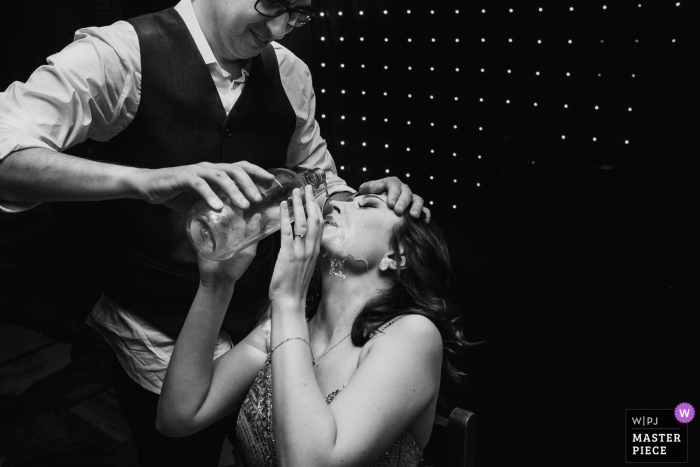Photo by: <a href="https://www.wpja.com/contests/2019-v15/best-wedding-photographers/2556445">Willian Mariot - Urussanga Santa Catarina</a> Kilombo Churrascaria wedding venue photo of the groom throwing rum in his sister's mouth