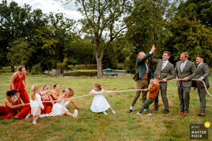 Photo by: <a href="https://www.wpja.com/contests/2019-v15/best-wedding-photographers/2556617">Paul Rogers - Hitchin Hertfordshire</a> Swallows Oast, Ticehurst, UK wedding reception photo of the bride and bridesmaids lose tug of war with groomsmen