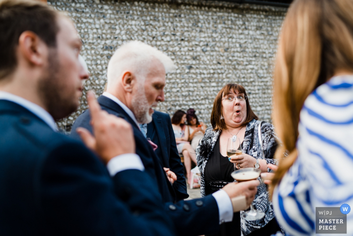 UK wedding guests laughing and having fun Cissbury Barns, West Sussex wedding photography — Oooooooooh cheeky!!!