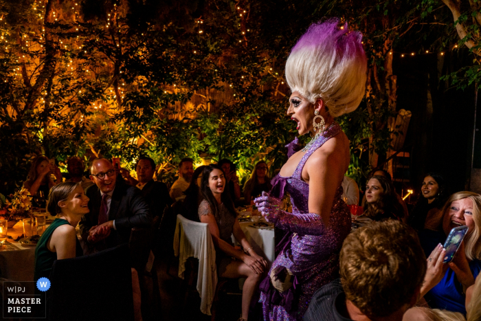 Photo by: <a href="https://www.wpja.com/contests/2019-v15/best-wedding-photographers/2557534">Brittany Diliberto - Arlington Virginia</a> wedding venue photography from Michael's Restaurant, Santa Monica CA | drag queen Leilani Lopez entertains everyone during dinner with a lip sync of "Poor Unfortunate Souls" by Ursula