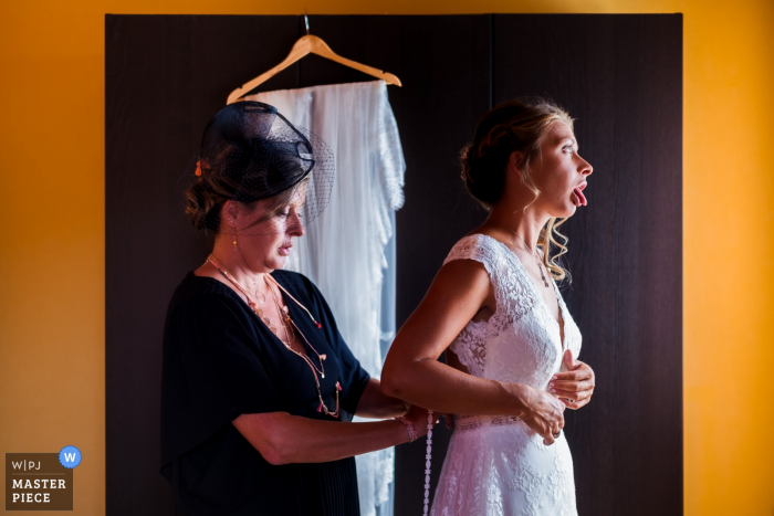 Photo by: <a href="https://www.wpja.com/contests/2019-v16/best-wedding-photographers/2560199">Benjamin Brette - St Ouen l'Aumone </a> l'isle adam - Bride getting dressed by her mother - France wedding photographer