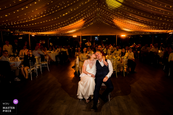 Photo by: <a href="https://www.wpja.com/contests/2019-v16/best-wedding-photographers/2560202">Benjamin Brette - St Ouen l'Aumone </a> Manoir de Grande commune wedding photos - bride and groom watching a slideshow