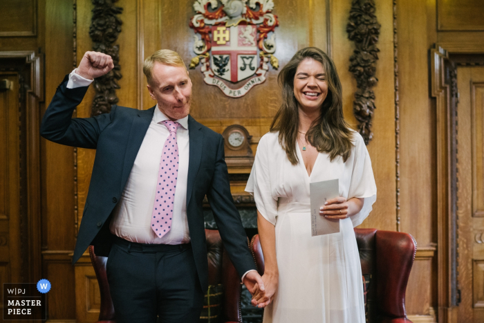Photo by: <a href="https://www.wpja.com/contests/2019-v16/best-wedding-photographers/2560496">Kari Bellamy - London</a> Wedding photography from Islington Town Hall, London, UK | Groom celebrating after getting married