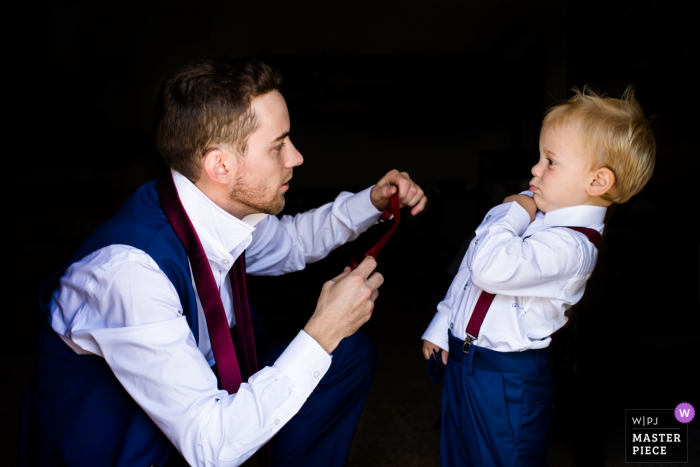 Photo by: <a href="https://www.wpja.com/contests/2019-v16/best-wedding-photographers/2560562">Rebekah Sampson - Payson Arizona</a> AZ wedding photographer: toddler's reaction to dad attempting to put on his tie