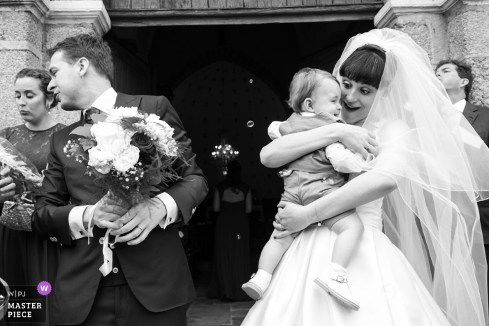 Photo by: <a href="https://www.wpja.com/contests/2019-v16/best-wedding-photographers/2560662">Valerie Teppe - Limoges </a> Wedding Photography for Cuzion | The bride with her child after the church ceremony