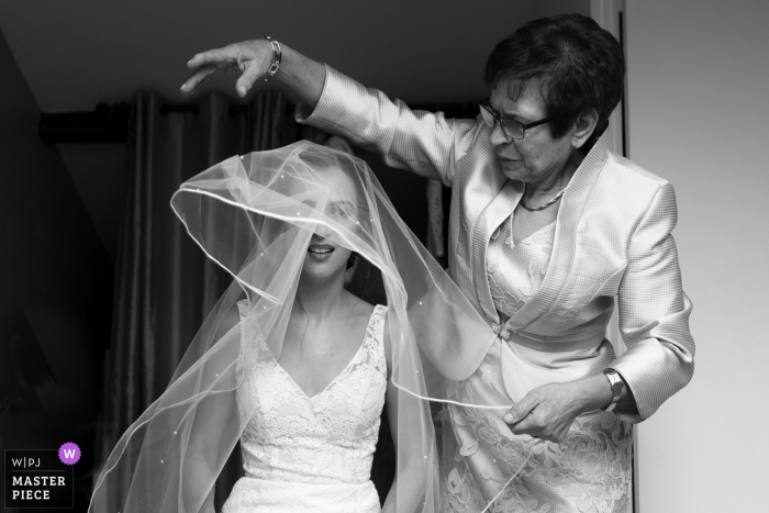 Photo by: <a href="https://www.wpja.com/contests/2019-v16/best-wedding-photographers/2560666">Valerie Teppe - Limoges </a> Paris wedding photographer: The mother of the bride is helping her with the veil