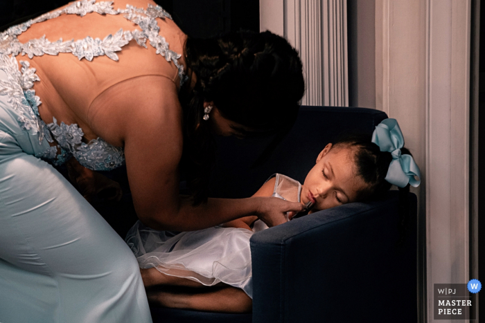 Photo by: <a href="https://www.wpja.com/contests/2019-v16/best-wedding-photographers/2560703">Lucas Coutinho - Nova Friburgo Rio de Janeiro</a> Brazil Make Up / Hair Salon Wedding Pictures | Bridesmaid getting her kid ready for the ceremony while shes asleep