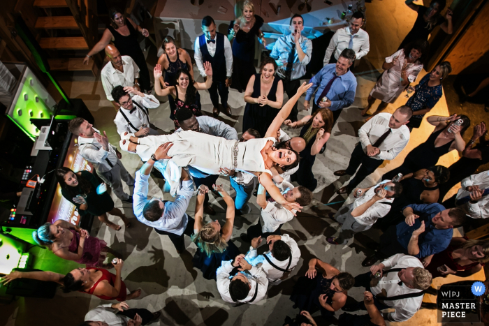 Photo by: <a href="https://www.wpja.com/contests/2019-v16/best-wedding-photographers/2560737">Todd Laffler - High Bridge New Jersey</a> Reception photography in New Jersey | Bride is lifted into the air during the wedding reception