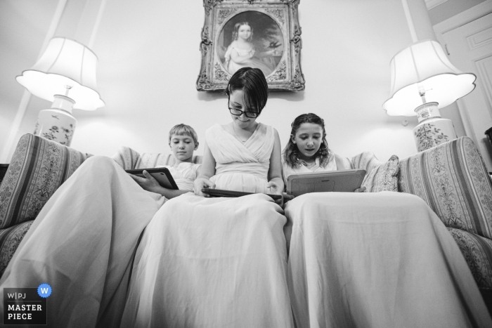 Photo by: <a href="https://www.wpja.com/contests/2019-v16/best-wedding-photographers/2560745">Andrew Morrell - Winchester Virginia</a> Whittemore House, Washington DC wedding venue photos | The junior bridesmaids whiling their time, waiting for the ceremony to begin, while their mother helps the bride with final dress adjustments.