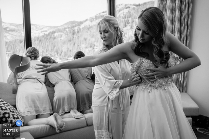 Photo by: <a href="https://www.wpja.com/contests/2019-v16/best-wedding-photographers/2560848">Shaunte Dittmar - Lake Tahoe California</a> Bride gets into her dress - Resort at Squaw - Wedding day photography of getting ready