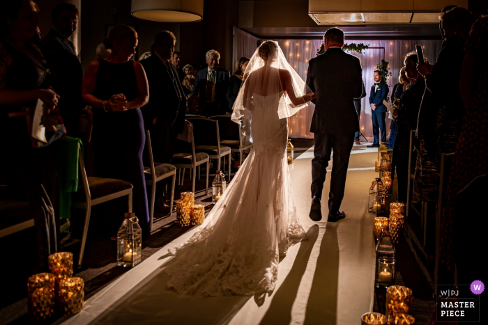 Photo by: <a href="https://www.wpja.com/contests/2019-v16/best-wedding-photographers/2561184">Victoria Sprung - Chicago Illinois</a> River Roast, Chicago, IL processional photography from the wedding ceremony with bride and her dad.