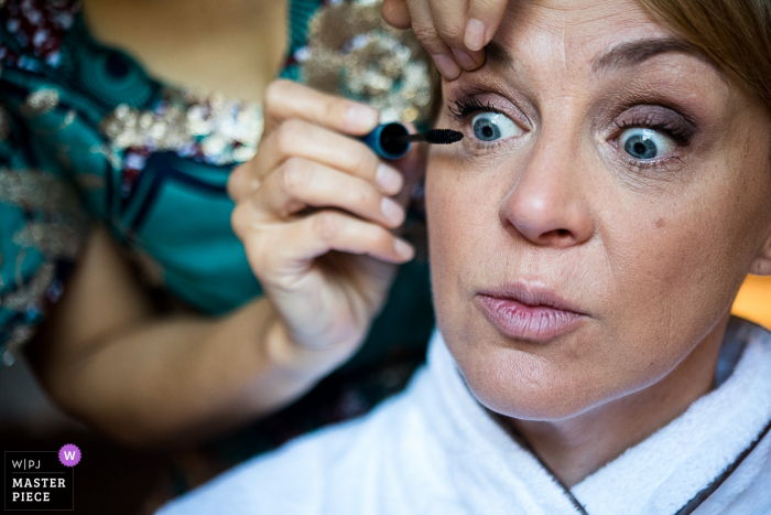 Photo by: <a href="https://www.wpja.com/contests/2019-v16/best-wedding-photographers/2561336">Nadine Court - Chambéry </a> Les fermes de Marie, Megève, France wedding photographer: Bride makes a funny face during her makeup