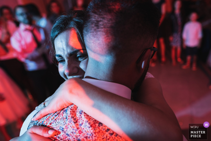 Photo by: <a href="https://www.wpja.com/contests/2019-v16/best-wedding-photographers/2561424">Patrick Lombaert - Plelan le Petit </a> Bruz, France First dance wedding photos under red reception lights