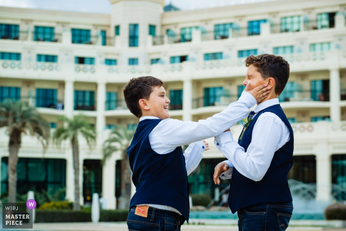 Photo by: <a href="https://www.wpja.com/contests/2019-v16/best-wedding-photographers/2561503">Antonio Calatayud - La Eliana Valencia</a> Valencia Spain Pre-Ceremony Wedding Photography - Boys slapping faces outside