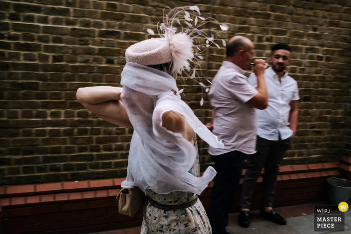 Photo by: <a href="https://www.wpja.com/contests/2019-v16/best-wedding-photographers/2561581">Kristian Leven - London</a> Wiltons Music Hall Wedding Venue Photographer - A Guest getting into the party spirit