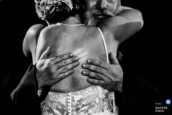 Duportail House Wayne PA wedding venue photography - Image of dad holding his daughter so tight he left his finger marks.