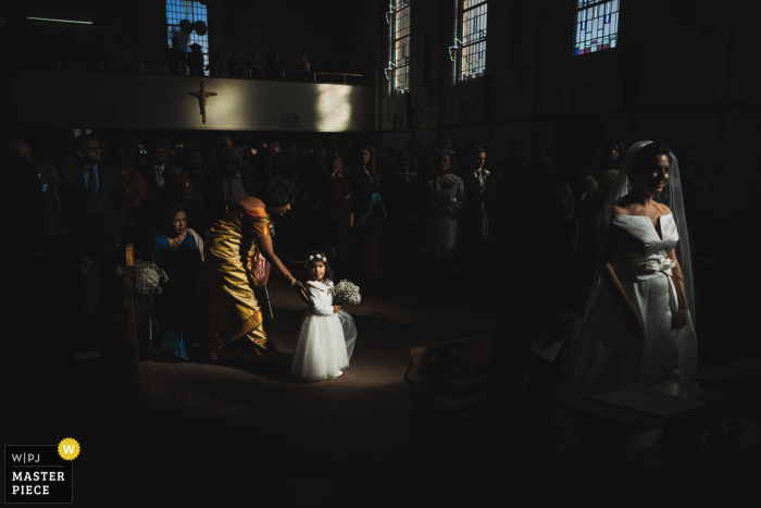 Photo by: <a href="https://www.wpja.com/contests/2019-v16/best-wedding-photographers/2561805">Richard Galloway - Frimley Green Surrey</a> St Erconwald's Church, Surrey wedding pictures - A flower girl caught in the sunlight