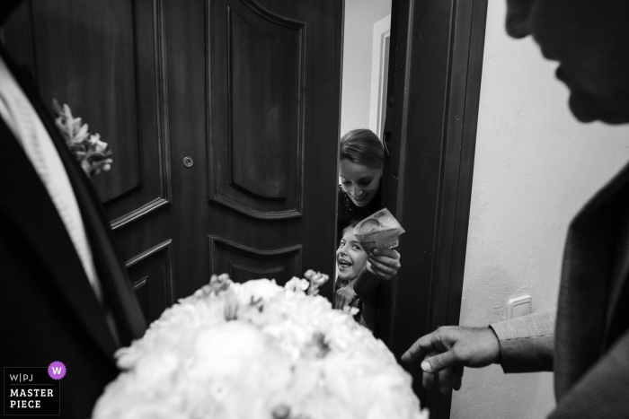 Photo by: <a href="https://www.wpja.com/contests/2019-v16/best-wedding-photographers/2561821">Derya Engin - Istanbul</a> The bride's house wedding day photography - The girl asking for money to show the bride