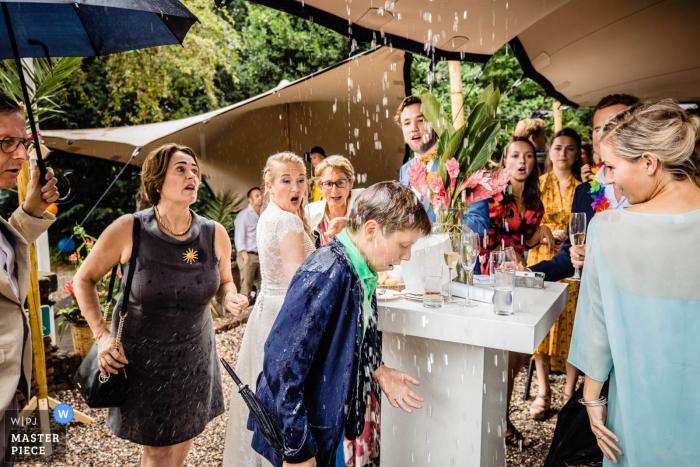 Photo by: <a href="https://www.wpja.com/contests/2019-v16/best-wedding-photographers/2561834">Freek Nagtzaam - 's-Hertogenbosch Noord Brabant</a> Rotterdam reception photography - wedding day rain gets some guests wet