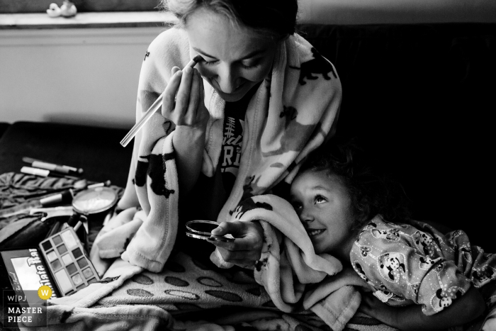 Photo by: <a href="https://www.wpja.com/contests/2019-v16/best-wedding-photographers/2561981">Sarah V. Martinez - Dover New Hampshire</a> Personal home in Nottingham New Hampshire photography | Getting wedding day makeup on while a little one excitedly looks on