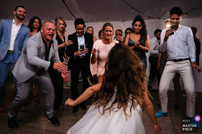 a young Girl steals the show on the dance floor while everyone cheers for her Flanders Party Photographer - Wedding Girl steals the show on the dance floor while everyone cheers for her
