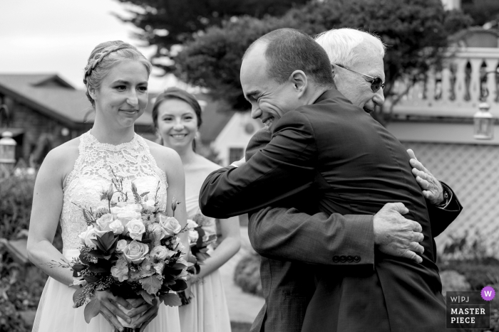 Photo by: <a href="https://www.wpja.com/contests/2019-v16/best-wedding-photographers/2562180">Joyce Perlman - San Francisco California</a> MacCallum House, Mendocino wedding photographer | Picture of the groom greeting the father in law as he hands off the bride