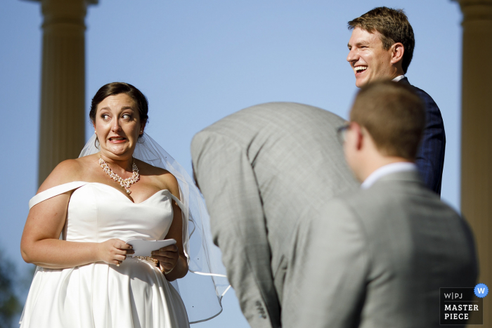 Photo by: <a href="https://www.wpja.com/contests/2019-v16/best-wedding-photographers/2562200">Justin Edmonds - Denver Colorado</a> City Park, Denver, CO wedding photography – The bride reacts while reading her vows during the wedding ceremony at City Park.
