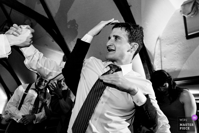 Photo by: <a href="https://www.wpja.com/contests/2019-v16/best-wedding-photographers/2562210">Kate Crabtree - Bangor Maine</a> Bar Harbor Club wedding venue photography in black and white – A groom dances on the dance floor