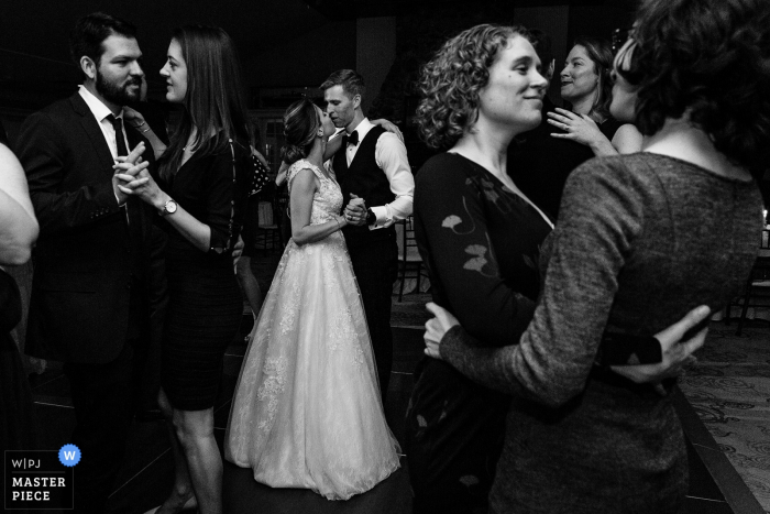 Photo by: <a href="https://www.wpja.com/contests/2019-v16/best-wedding-photographers/2562214">Kate Crabtree - Bangor Maine</a> Northport, Maine wedding photographer – A bride and groom slow dance with other guests on their dance floor