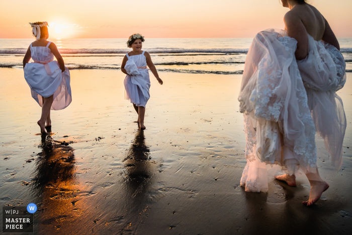Photo by: <a href="https://www.wpja.com/contests/2019-v17/best-wedding-photographers/2562749">Kristina Cazares Neri - San Diego California</a> Del Mar, Ca Wedding Photographer \ Flower girls and bride are enjoying sunset on the beach before the reception