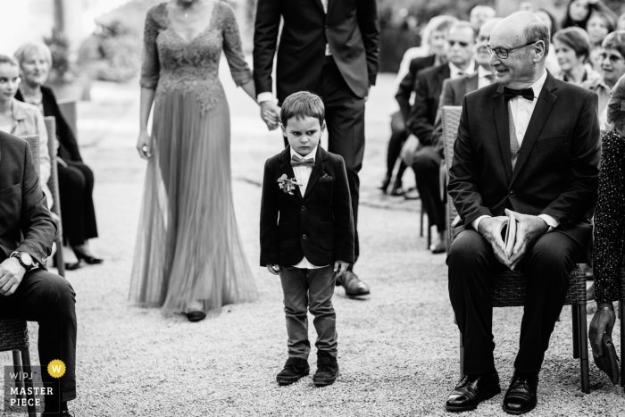 Photo by: <a href="https://www.wpja.com/contests/2019-v17/best-wedding-photographers/2562773">Charlène Aubert - Novalaise </a> Auvergne-Rhône-Alpes wedding ceremony pictures of an unhappy little ring bearer walking down the aisle.