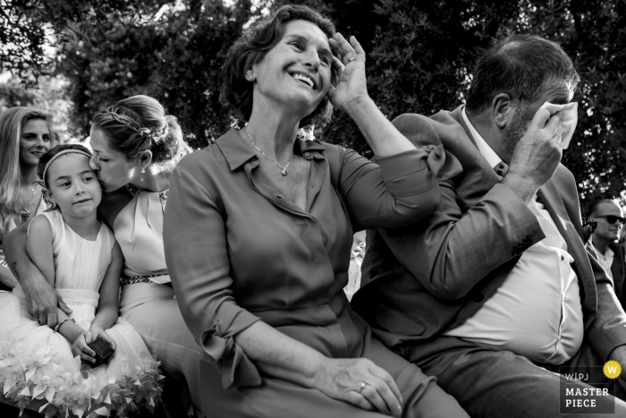 Photo by: <a href="https://www.wpja.com/contests/2019-v17/best-wedding-photographers/2562802">Sanne De Block - Wijnegem Antwerpen</a> Puglia outdoor wedding ceremony photos of family and guests wiping tears.