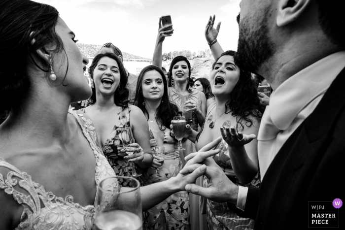 Photo by: <a href="https://www.wpja.com/contests/2019-v17/best-wedding-photographers/2563510">Vinicius Terror - Ouro Preto Minas Gerais</a> Brazil Reception Venue wedding photography of guests in black and white with the bride and groom
