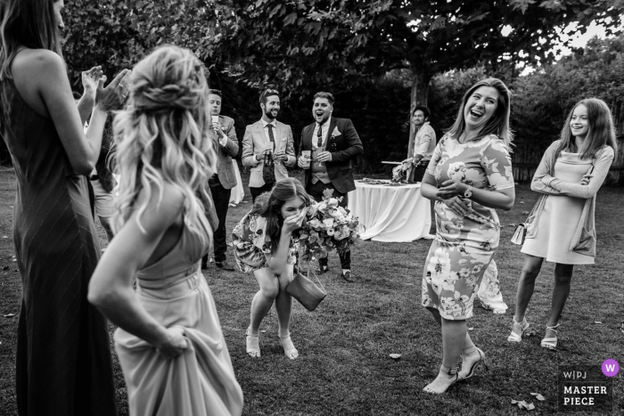 Photo by: <a href="https://www.wpja.com/contests/2019-v17/best-wedding-photographers/2563653">Florent Cattelain - Labarthe-sur-Lèze </a> Mas de Peint, Camargue, France wedding photo of guest as she grabbed the bride's bouquet