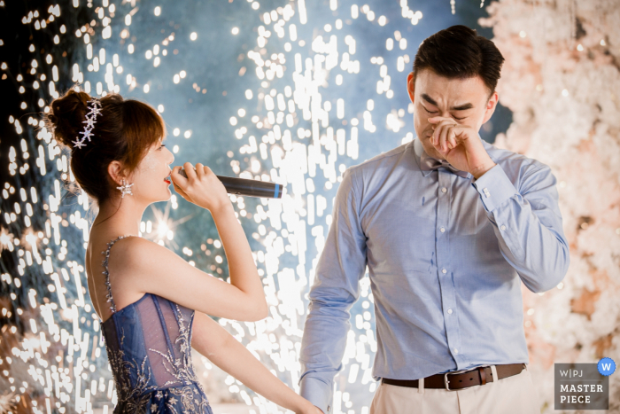 Photo by: <a href="https://www.wpja.com/contests/2019-v17/best-wedding-photographers/2563689">Yudi Shao - Hangzhou </a> Bali Island wedding venue photography of bride and groom with speech, tears, fireworks and song.