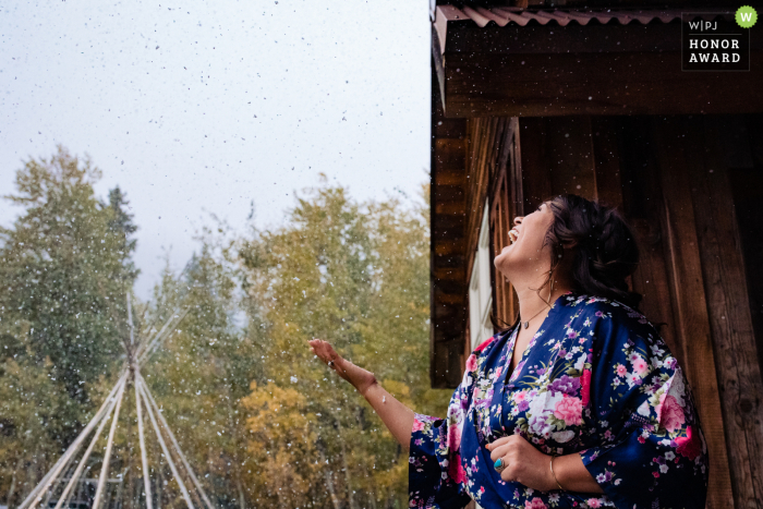 Victor, Idaho wedding photo: bridesmaid enjoys falling snow 