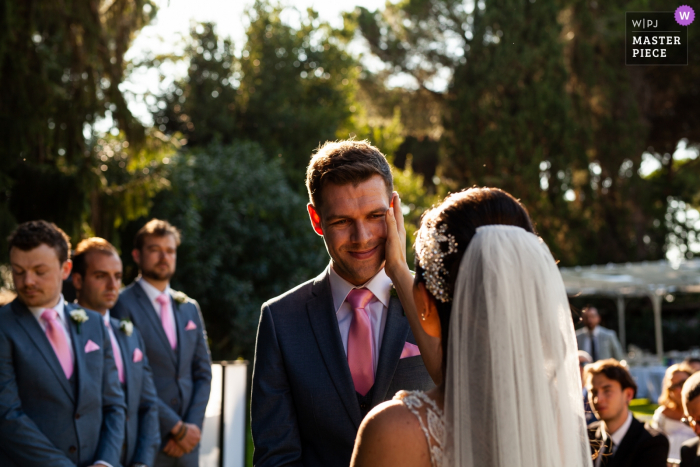 Photo by: <a href="https://www.wpja.com/contests/2019-v17/best-wedding-photographers/2564334">Zsofia Rebicek - Orvieto Terni</a> Villa Trebzia - Rome Italy / ceremony photography as the bride wipes a tear from the groom during the ceremony