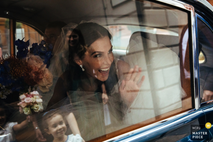 Photo by: <a href="https://www.wpja.com/contests/2019-v17/best-wedding-photographers/2564356">Lyndsey Goddard - London London</a> St Bride's Church, London wedding ceremony photography - Bride waves at the flowergirl as she arrives for the ceremony