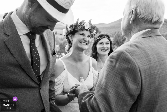 Photo by: <a href="https://www.wpja.com/contests/2019-v17/best-wedding-photographers/2564372">Brenda Bergreen - Evergreen Colorado</a> Grandby, CO outdoor wedding venue photography – Bride greeting father during ceremony