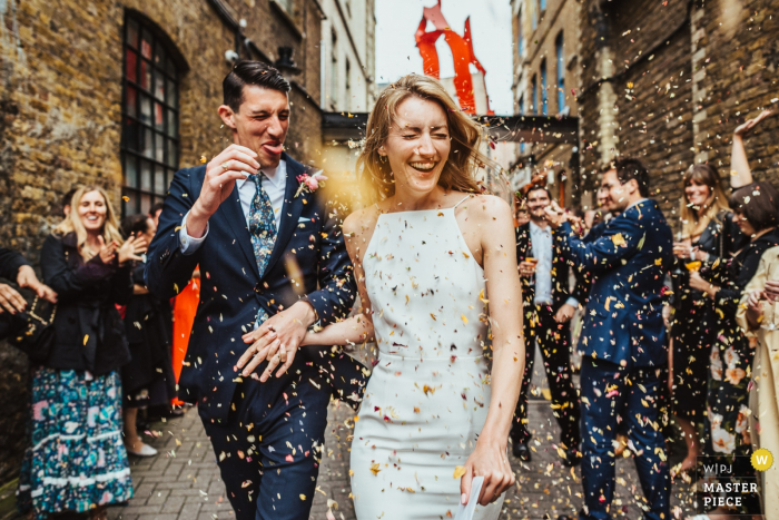 Photo by: <a href="https://www.wpja.com/contests/2019-v17/best-wedding-photographers/2564515">Mark Wallis - Belper Derbyshire</a> First Option Location Studios, Hackney, London wedding photography. Confetti is thrown at a bride and groom