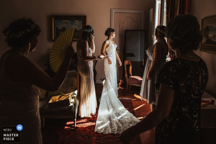 Photo by: <a href="https://www.wpja.com/contests/2019-v17/best-wedding-photographers/2564522">Mark Wallis - Belper Derbyshire</a> A bride is surrounded by her bridesmaids before her wedding ceremony - wedding photos from Château de Roquelune, Pezenas, France