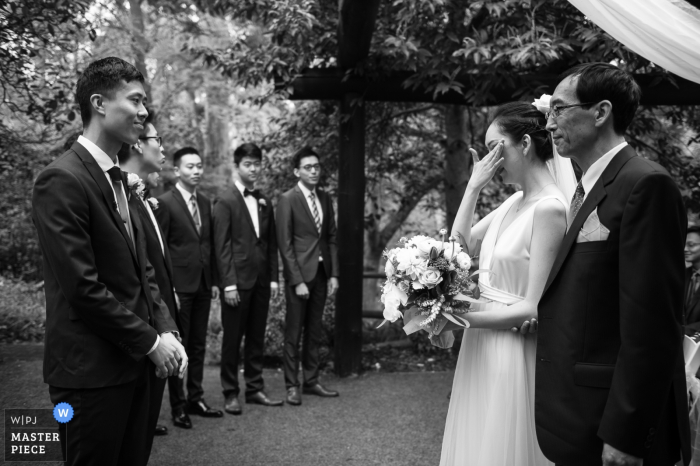 Photo by: <a href="https://www.wpja.com/contests/2019-v17/best-wedding-photographers/2564635">Jiake Yang - Melbourne Victoria</a> Victoria-AU wedding photographer: The bride's father gave his daughter to the groom at the outdoor ceremony with tears.