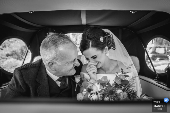 Photo by: <a href="https://www.wpja.com/contests/2019-v17/best-wedding-photographers/2564746">Mike Cook - Larbert Stirlingshire</a> Scotland Wedding Auto Ride Photography | Bride & father arrive in the wedding car.