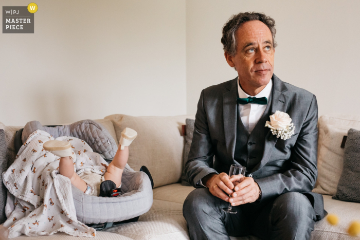 Photo by: <a href="https://www.wpja.com/contests/2019-v17/best-wedding-photographers/2564789">Fille Roelants - Antwerpen Antwerpen</a> Antwerpen wedding photographer pro: bride and groom's house baby is not up for sleeping yet while her granddad is sitting next to her
