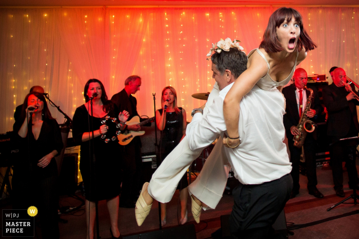 Photo by: <a href="https://www.wpja.com/contests/2019-v17/best-wedding-photographers/2564835">Martin Dabek - Bristol Bristol</a> Hensol Castle wedding venue reception photography of Dancing with the band behind them