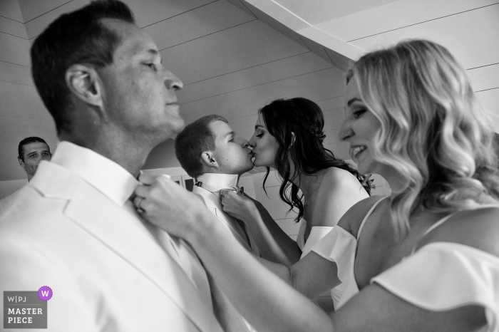 Photo by: <a href="https://www.wpja.com/contests/2019-v17/best-wedding-photographers/2565067">Matt Theilen - South Lake Tahoe California</a> Tahoma, California wedding photographer – Bridesmaids helping groom and best man with ties.